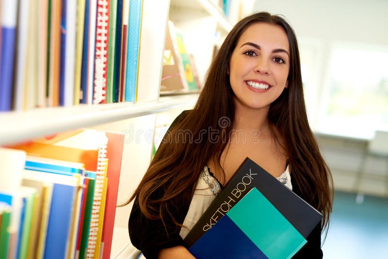 Happy young art student at the college library stock image Happy young art student at the college library stock image