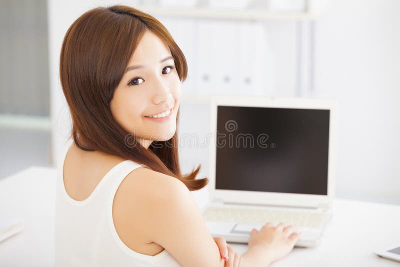 Happy young asian woman using a laptop royalty free stock photos