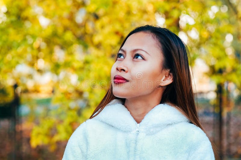 Happy young beautiful woman in autumn park on sunny day, Young woman in white coat during sunset in the park royalty free stock photos Happy young beautiful woman in autumn park on sunny day, Young woman in white coat during sunset in the park royalty free stock photos