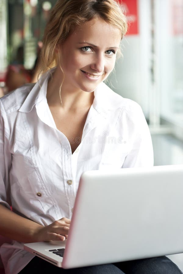 Happy young beautiful woman with laptop - indoors