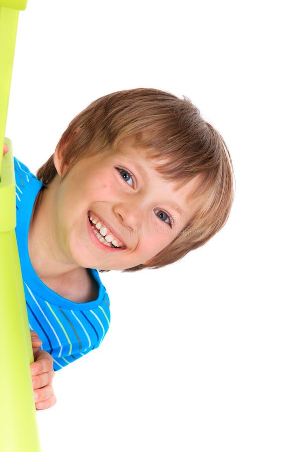 Happy young boy. Portrait of happy young boy looking around green object with white background and copy space stock photo Happy young boy. Portrait of happy young boy looking around green object with white background and copy space stock photo