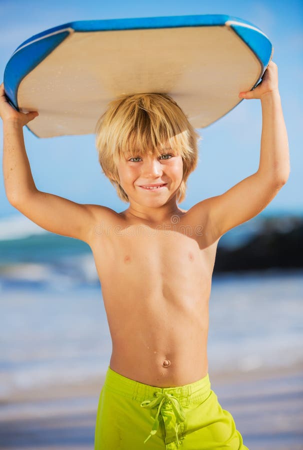 Happy Young boy having fun at the beach on vacation