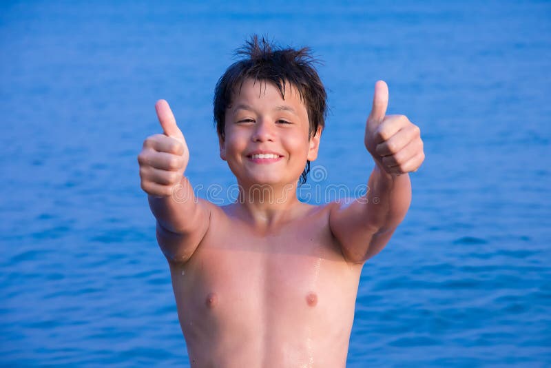 Happy young boy on the sea beach OK