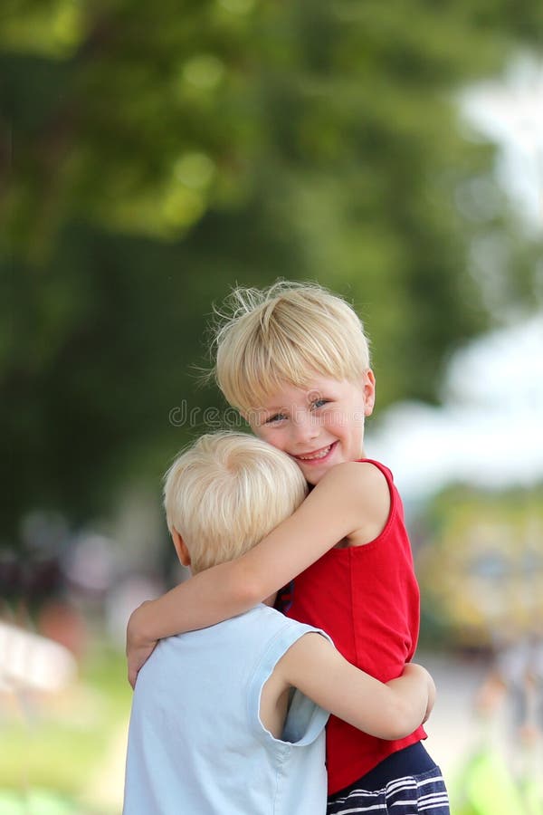 Happy Young Brothers Hug Outside royalty free stock images Happy Young Brothers Hug Outside royalty free stock images