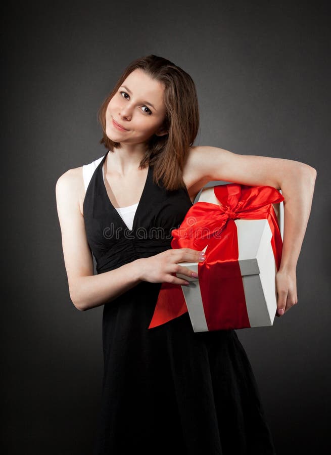 Happy young brunette girl with present