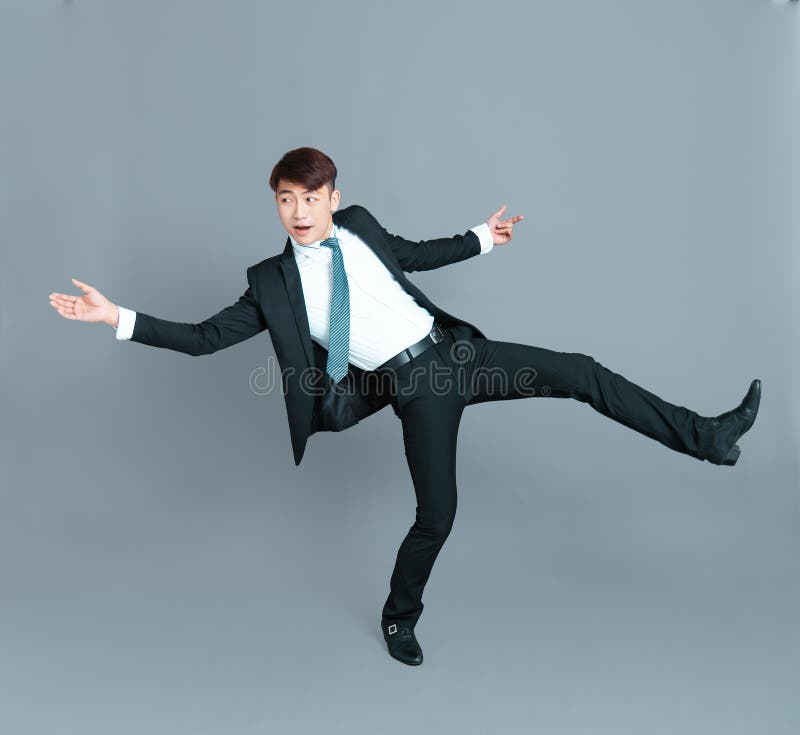 happy-young-business-man-dancing-motion-166540387.jpg