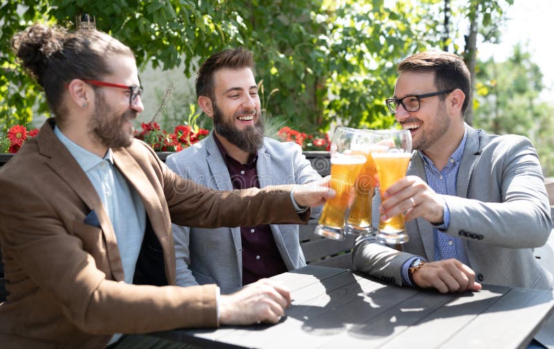 Happy Young Business Men Talking and Drinking Beer in a Pub Stock Image ...