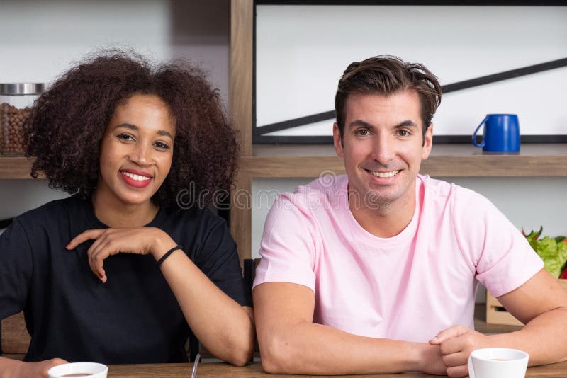 Happy young couple in a coffee house having breakfast stock photo Happy young couple in a coffee house having breakfast stock photo