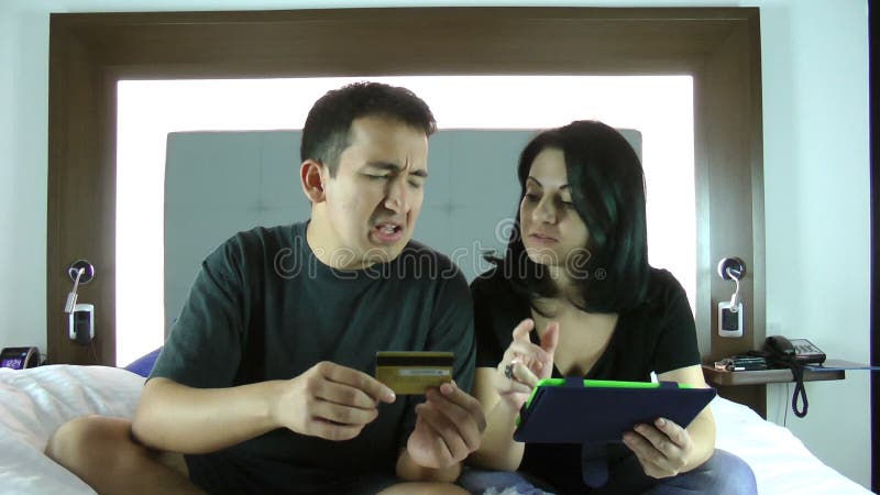 Happy young couple doing shopping on internet in the tablet device