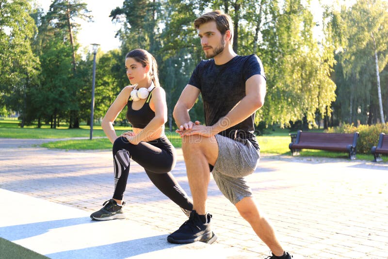 Happy young couple exercising together in a park royalty free stock image Happy young couple exercising together in a park royalty free stock image