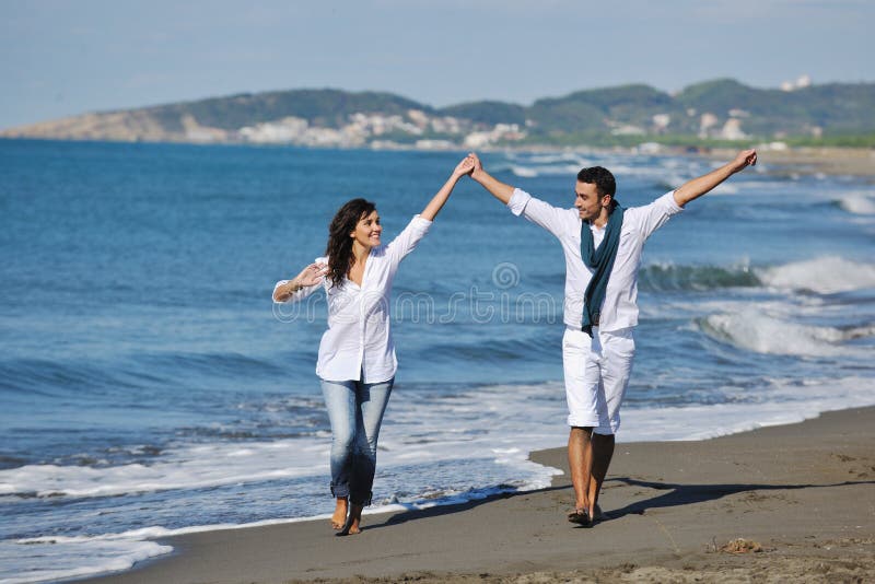 Happy young couple have fun at beautiful beach royalty free stock photo