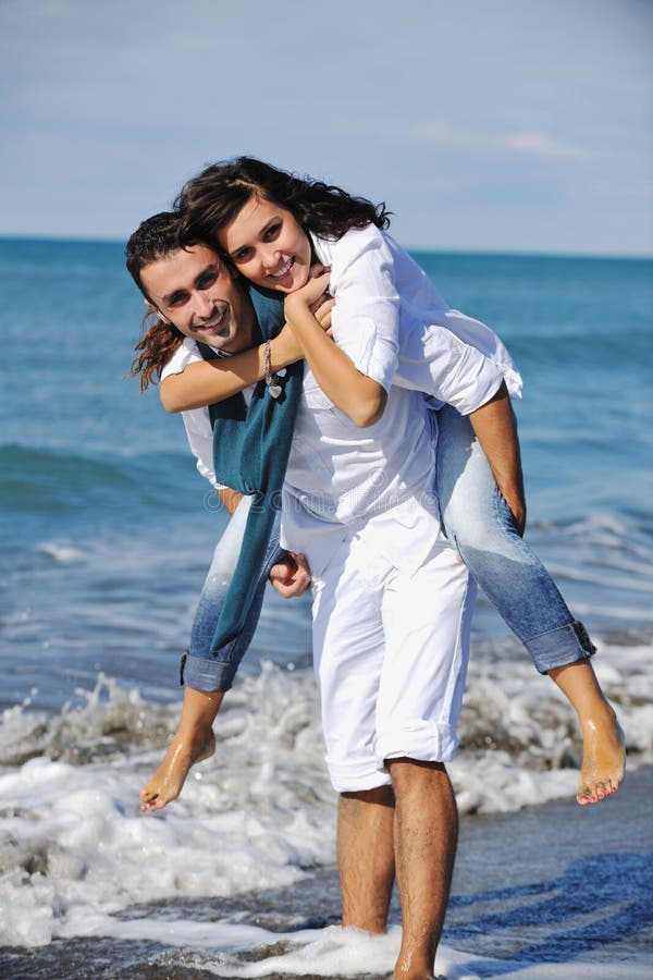 Happy young couple have fun at beautiful beach