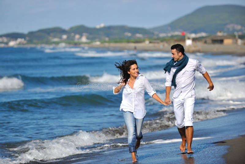 Happy young couple have fun at beautiful beach