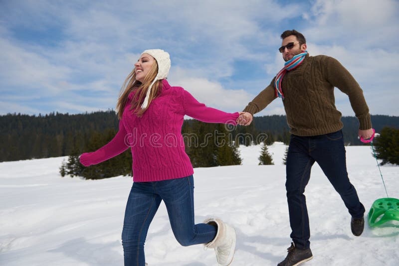 Happy Young Couple Having Fun On Fresh Show On Winter