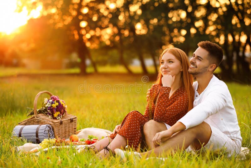 Happy young couple having picnic