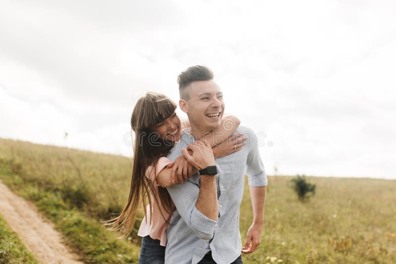 Happy young couple hugging and laughing outdoors. Love and tenderness. Lifestyle concept royalty free stock photos Happy young couple hugging and laughing outdoors. Love and tenderness. Lifestyle concept royalty free stock photos
