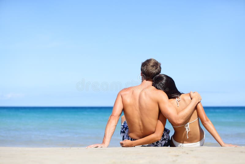 Happy young couple in love relaxing beach vacation stock images