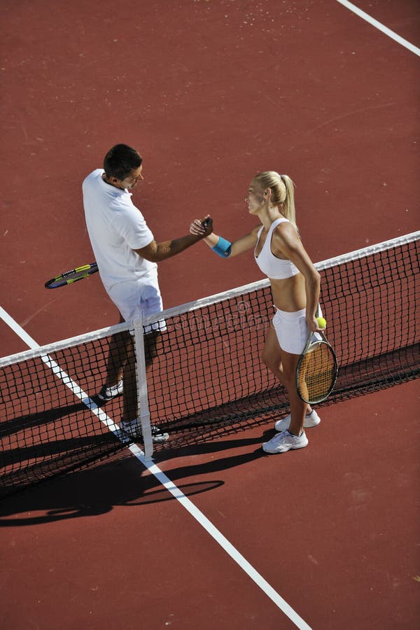 Happy young couple play tennis game outdoor