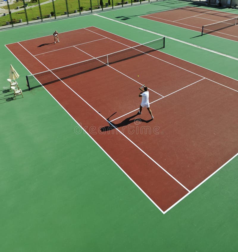 Happy young couple play tennis game outdoor