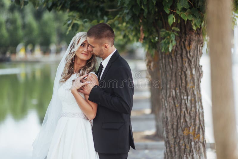 Happy young couple poses for photographers on her happiest day. royalty free stock photos Happy young couple poses for photographers on her happiest day. royalty free stock photos