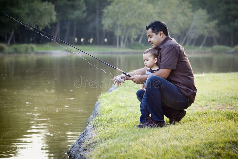 Happy Young Ethnic Father and Son Fishing