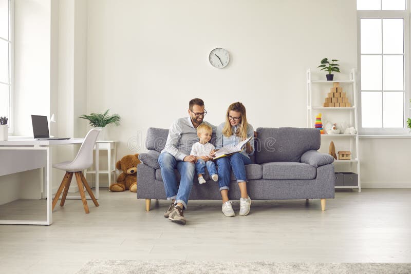 Happy Young Mom And Dad Sitting On Comfy Couch At Home Reading Book Together With Their Little Son Stock Image Image Of Minimalist Light Happy Young Mom And Dad Sitting On Comfy Couch At Home Reading Book Together With Their Little Son Stock Image Image Of Minimalist Light