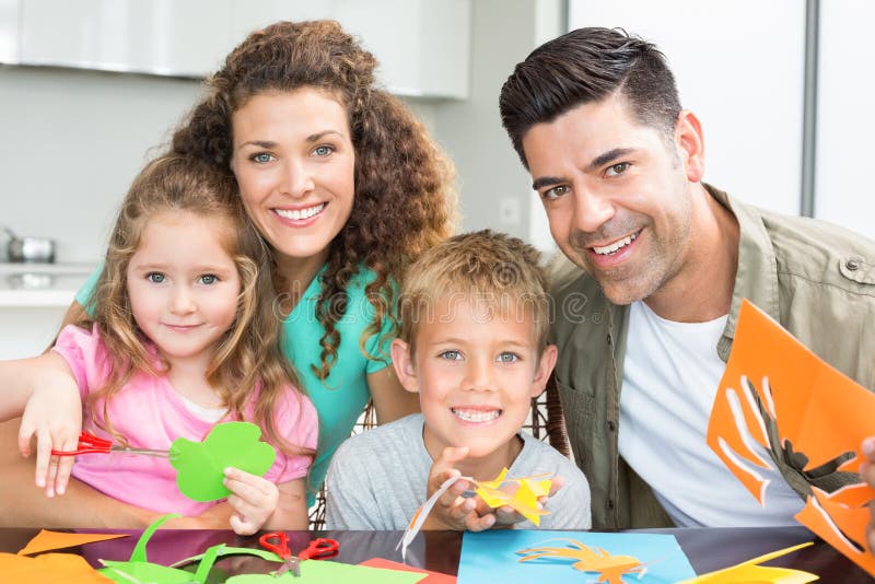 Happy Young Family Doing Arts and Crafts at the Table Stock Image ...