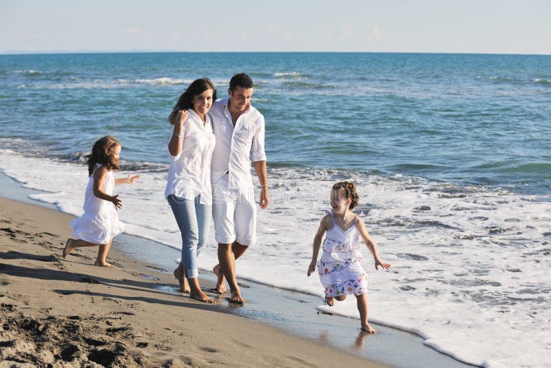 Happy young family have fun on beach