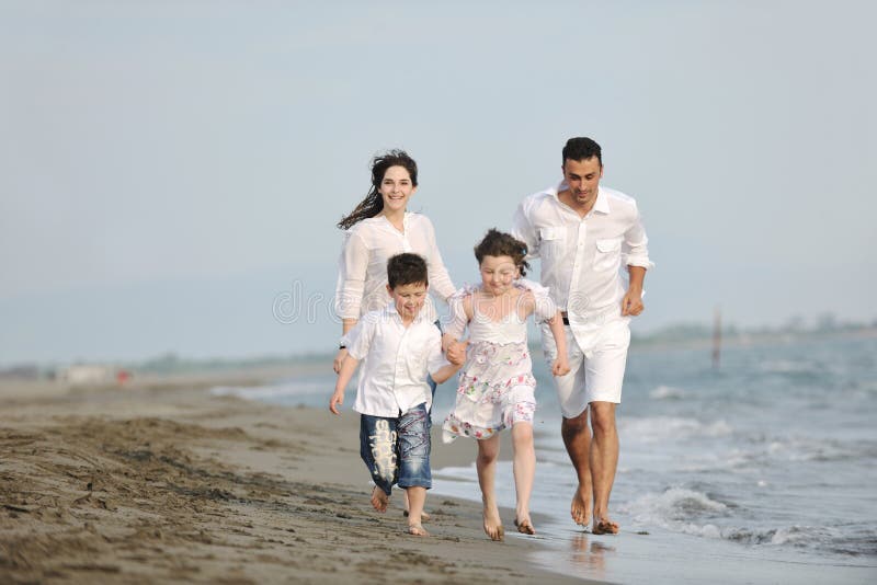 Happy young family have fun on beach