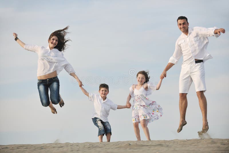 Happy young family have fun on beach