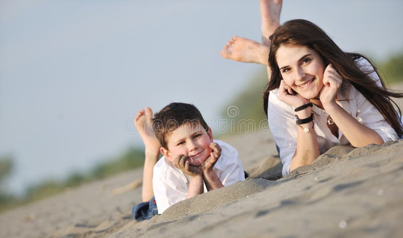 Happy young family have fun on beach