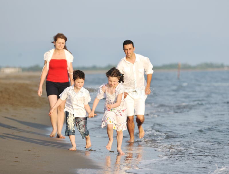 Happy young family have fun on beach