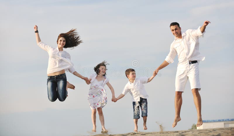 Happy young family have fun on beach