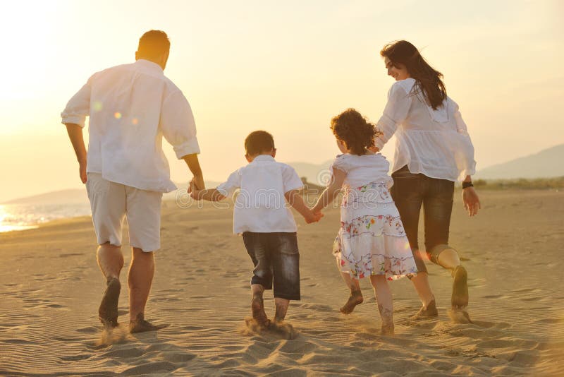 Happy young family have fun on beach