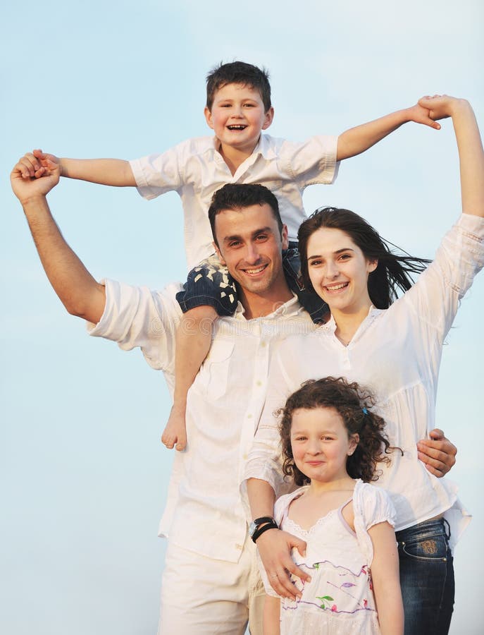 Happy young family have fun on beach