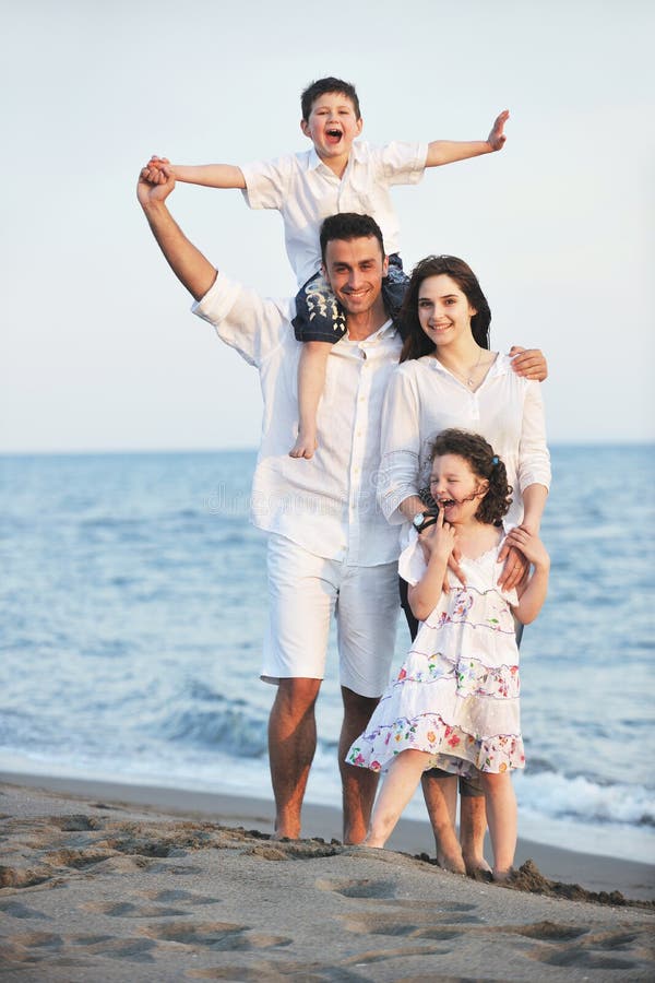 Happy young family have fun on beach