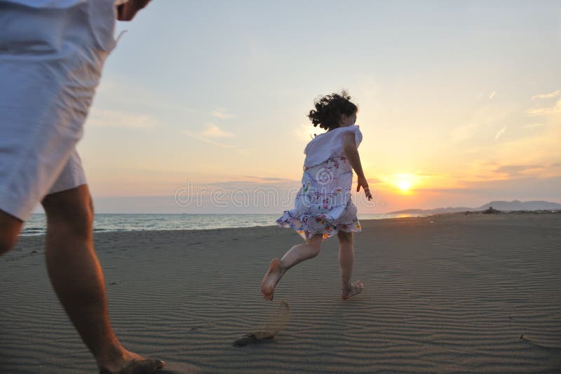 Happy young family have fun on beach