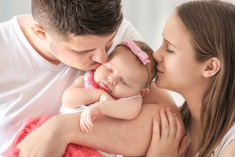 Happy young family holding cute sleeping newborn baby royalty free stock photo Happy young family holding cute sleeping newborn baby royalty free stock photo