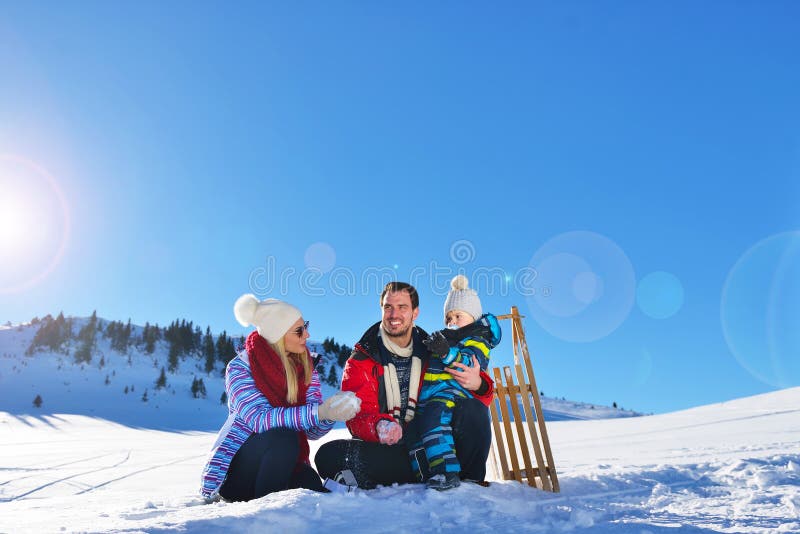 Happy young family playing in fresh snow at beautiful sunny winter day outdoor in nature. Daughter, outdoors.