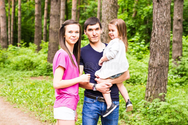 Happy young family spending time outdoor on a summer day royalty free stock photo Happy young family spending time outdoor on a summer day royalty free stock photo