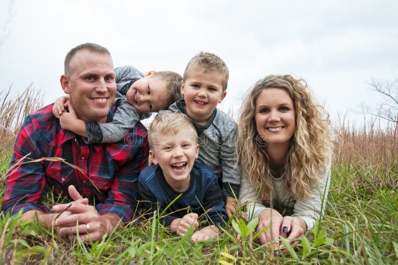 Happy young family with three little boys stock images Happy young family with three little boys stock images