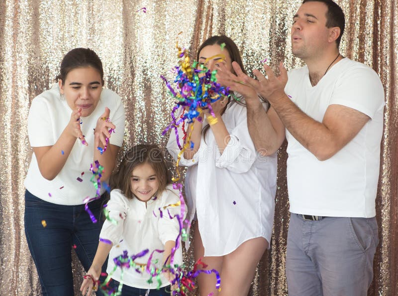 Happy young family having fun with confetti stock image Happy young family having fun with confetti stock image