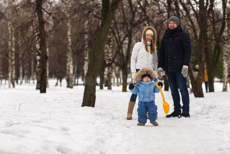 Happy Young Family Walking in a Winter Park Stock Photo - Image of ...