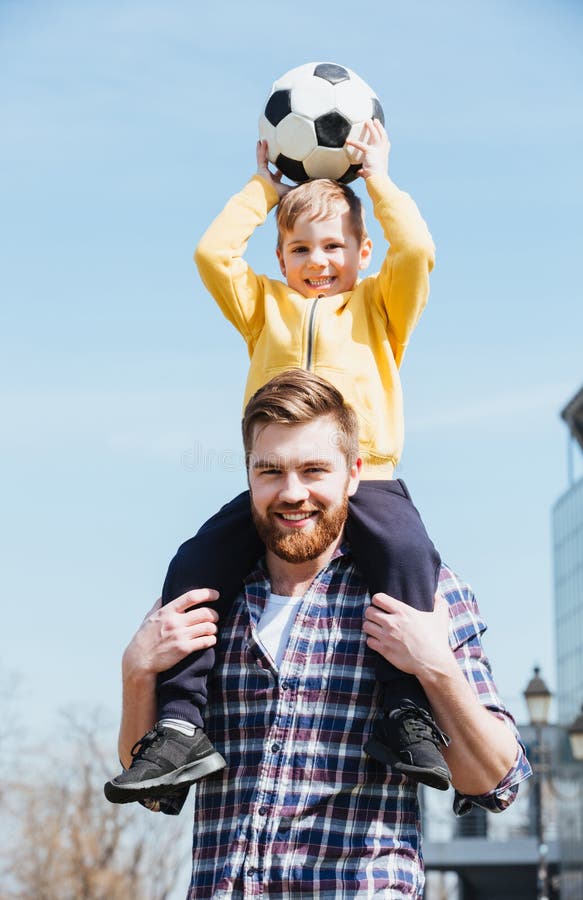 Happy young father carrying his little son on shoulders royalty free stock photos Happy young father carrying his little son on shoulders royalty free stock photos