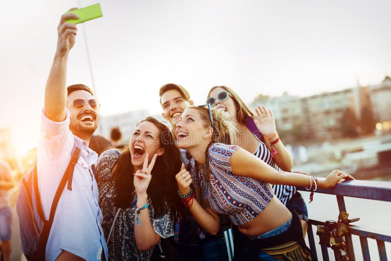 Happy young friends taking selfie on street stock image Happy young friends taking selfie on street stock image