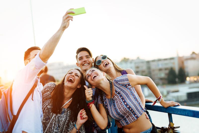 Happy young friends taking selfie on street royalty free stock photography Happy young friends taking selfie on street royalty free stock photography
