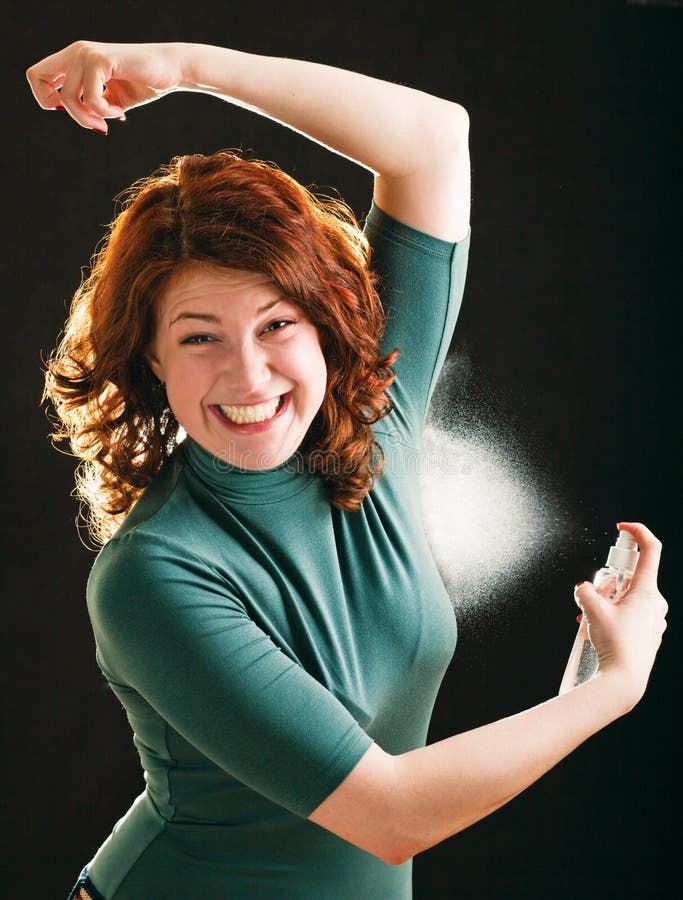 Happy young girl with deodorant on white background