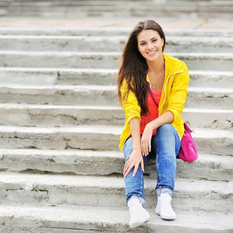 Happy Young Girl Sitting on the Stairs and Smiling Stock Photo - Image ...