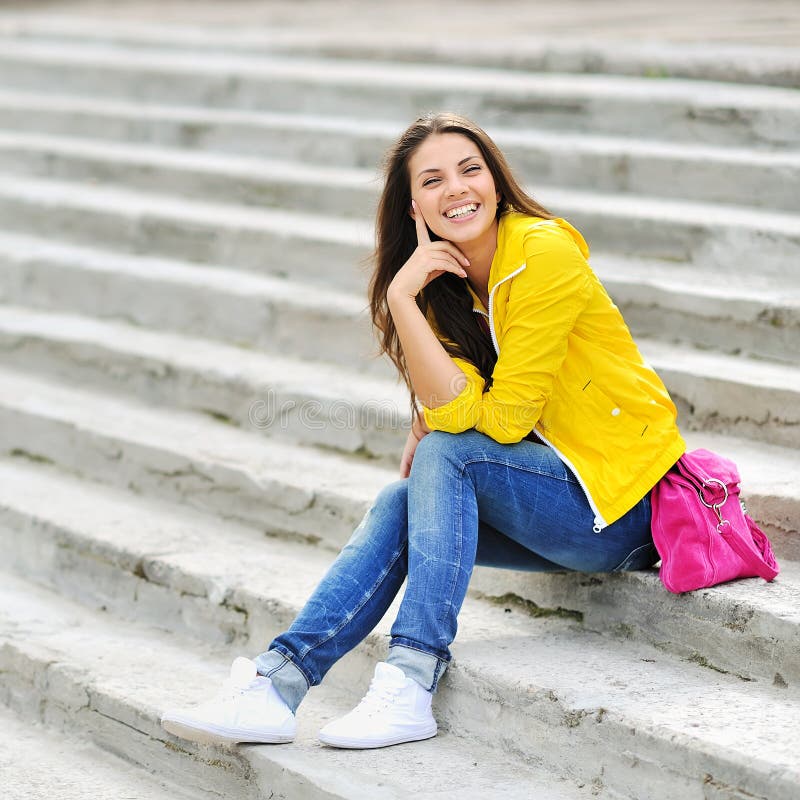 Happy Young Girl Sitting on the Stairs and Smiling Stock Image - Image ...