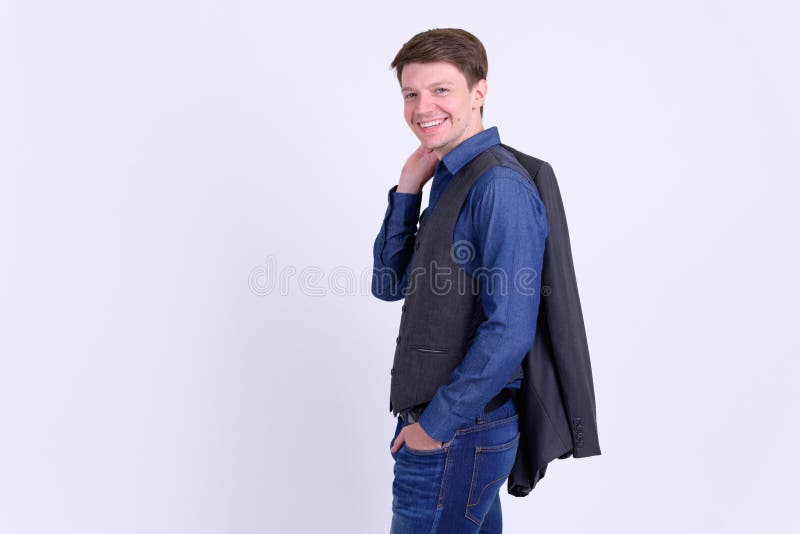 Happy Young Handsome Businessman In Suit Carrying Jacket Over Shoulder